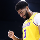 Pictured: Los Angeles Lakers star Anthony Davis looking down at the roof of a two-story building, just out of frame